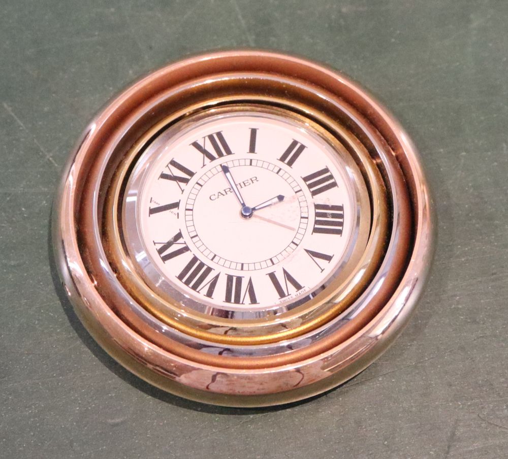 A Cartier three colour metal swivelling travelling timepiece, numbered 563138GD over 2859.